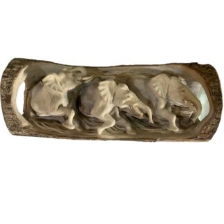 Elephant herd carved into log